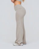Beige high-waisted pants worn by a person on a white background