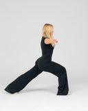 Person wearing a black outfit performing a yoga pose on a white background