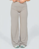 Beige wide-leg pants worn by a person on a light gray background