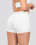 White athletic shorts worn by a person on a light gray background