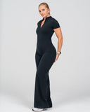 Woman wearing a black jumpsuit on a white background